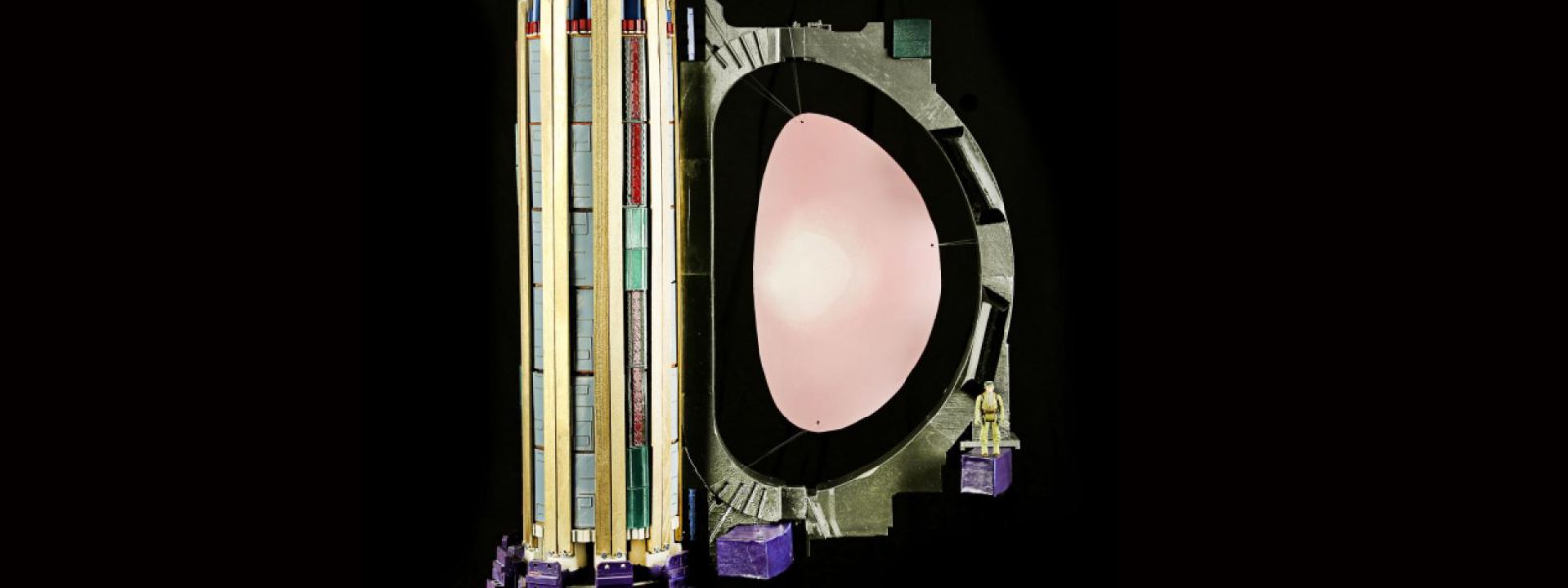 A “toy”-sized, but accurately scaled, version of the ITER central solenoid (left) with one of the 18 toroidal field coils, printed on a desktop 3D printer. The pink oval represents the plasma. Notice the action figure at right showing the model’s scale. Photo: US ITER/ORNL