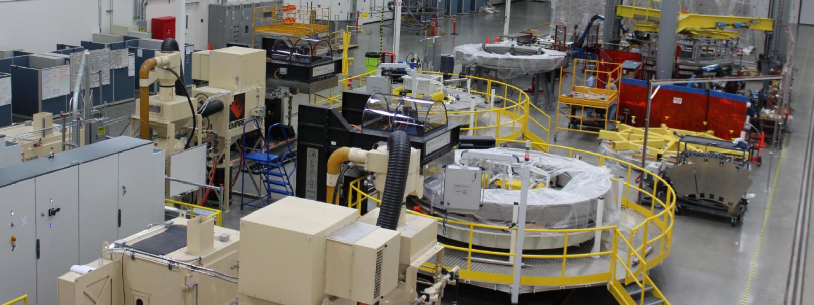 A partial view of the General Atomics module fabrication line, with two winding station tables visible behind a yellow rail. Photo: GA