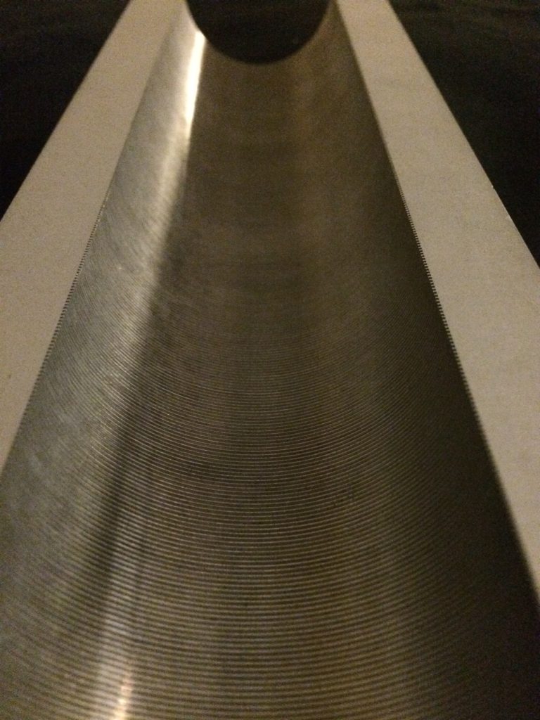 Evacuated wave guide with fine corrugations