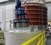 The vacuum pressure impregnation station includes a resin reservoir (foreground) and a vacuum chamber that can hold a seven foot tall module. Photo:GA